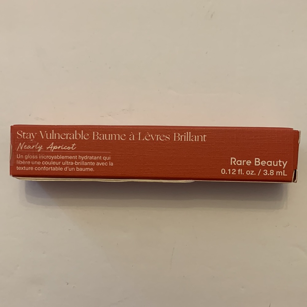 Rare Beauty Stay Vulnerable Nearly Apricot Glossy Lip Balm.